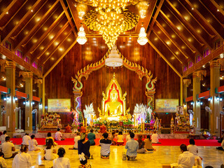 Fototapeta na wymiar Ubon Ratchathani, Thailand - July 13, 2022; Holy days People make merit at the beautiful Maha Wanaram Temple, one of the famous temples, in Ratchathani Province, Thailand.