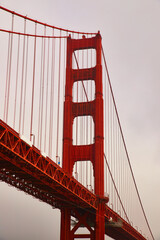 Vertical of part of Golden Gate Bridge on foggy morning