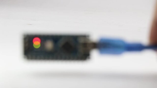 Bokeh lights from a blinking programmable microcontroller board that is used to make inventions and interesting electronic projects