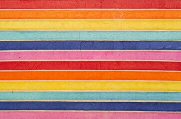 horizontally colored or multi-colored striped pattern background, recycled and organic material. Fiber textured paper.
