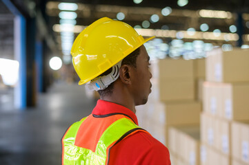 Portrait of young mixed race male worker wearing helmet in modern warehouse storage of retail shop