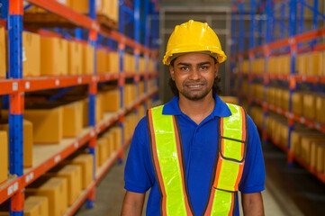 Portrait of young mixed race male worker wearing helmet in modern warehouse storage of retail shop