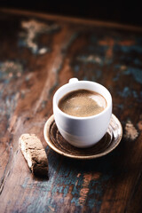 Cup of coffee and Cantuccini (Italian cookie) on dark wooden background. Close up. Copy space.