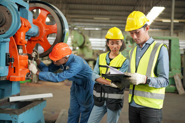 Team maintenance engineers men and women inspect relay protection system with laptop comp. They...