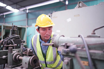 Portrait of a Professional Heavy Industry Engineer Worker Wearing Uniform, Glasses and Hard Hat in a Steel Factory. Industrial Specialist Standing in Metal Construction Facility.