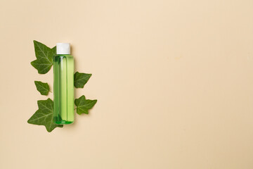 Cosmetic product with ivy extract on color background, top view