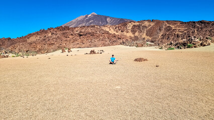 Rear view of yoga man with scenic view on moon desert landscape of Minas de San Jose Sur near...