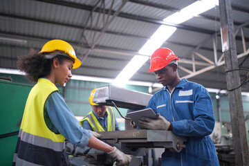 Team maintenance engineers men and women inspect relay protection system with laptop comp. They...