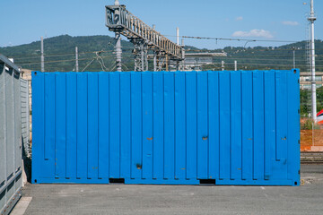 Transport of goods: this blue container is full of material, near the station ready to be loaded on freight wagons, to reach store warehouses.