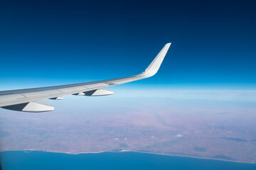 Aerial window view from an airplane on the African coast of Morocco. Hill and mountain landscape. Flying high above ground. Freedom. Coastline of Atlantic Ocean. Commercial flight from Canary Islands