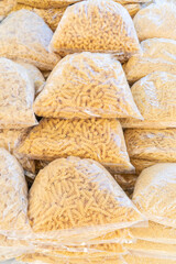 raw pasta in a transparent plastic bag as a background