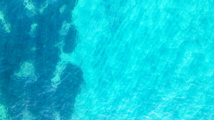 The color of the water and beautifully bright. Aerial view of a crystal clear sea water texture. Sea from a drone. Blue sea surface from above. Sea surface aerial view