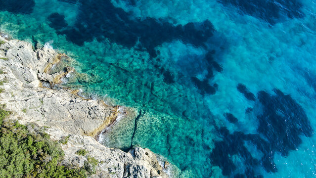 Aerial birds eye view photo taken by drone depicting beautiful deep blue turquoise waters and lovely rocky seascape in Greece © Nenad