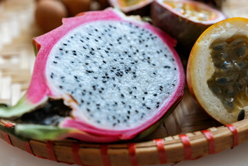 Fototapeta na wymiar Slice of fresh Pitaya or Pitahaya fruit with clipping path. Natural light from the window.