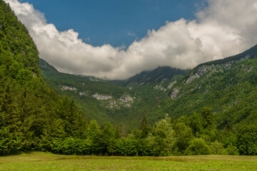 Fototapeta na wymiar Landscape under Triglav national Slovenia hill with white dense clouds