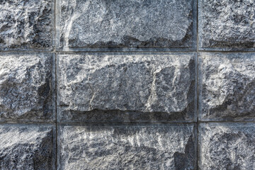 Masonry walls of gray granite close-up. Texture and pattern of natural stone