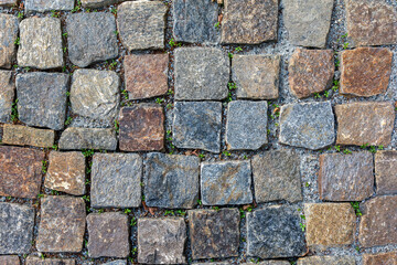 A fragment of an ancient destroyed paving stone in close-up. Texture and pattern of masonry