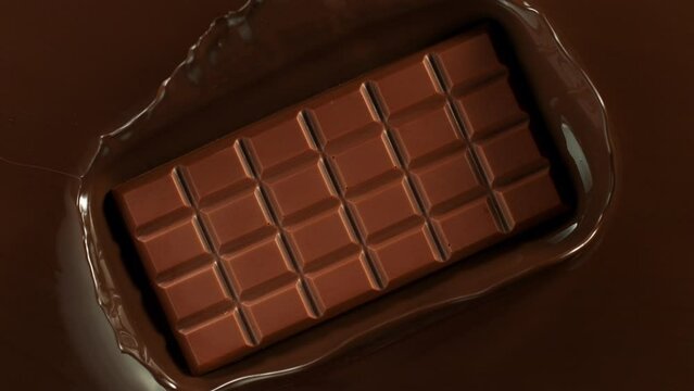 Super Slow Motion of Chocolate Bar Splashing Up From Melted Chocolate. Filmed with High Speed Cinema Camera, 1000fps.