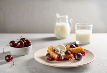 Homemade sweet cherry pie or red brownie cake. One piece with ice cream on plate, milk and raw cherries aside