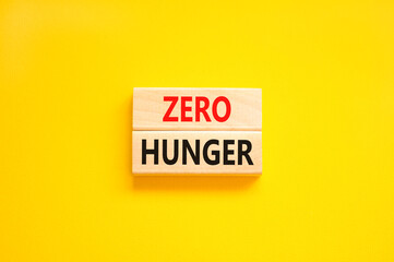 Zero hunger symbol. Concept words Zero hunger on wooden blocks on a beautiful yellow table yellow background. Business, support and Zero hunger concept. Copy space.