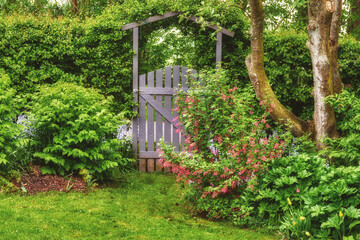 A scenic garden landscape wrapped in greenery, bushes, flowers and trees. A beautiful backyard...