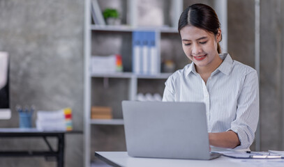 Portrait of Accountant Young Asian female working on a laptop, doing calculator planning analyzing the financial report, business plan investment, finance analysis concept