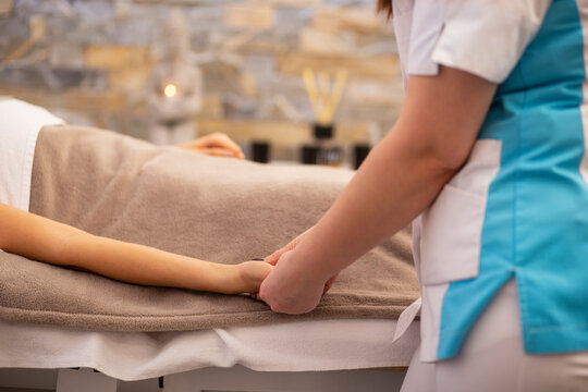 Cropped image of woman receiving hand massage at spa. Horizontal view.