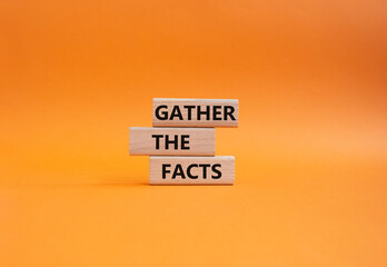 Gather the facts symbol. Wooden blocks with words Gather the facts. Beautiful orange background....