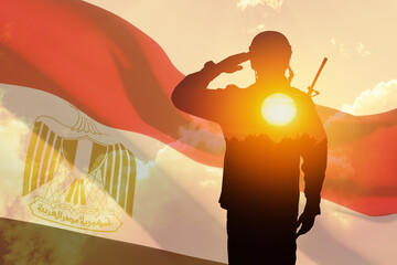 Double exposure of silhouette of a solider and the sunset or the sunrise against flag of Egypt. Greeting card for Independence day, Memorial Day, Armed forces day, Sinai Liberation Day.