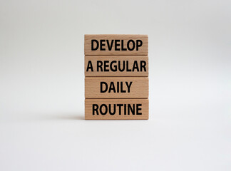 Develop a regular daily routine symbol. Concept words Develop a regular daily routine on wooden blocks. Beautiful white background. Business and Develop a regular daily routineconcept. Copy space.
