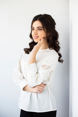 Beauty profile portrait of a cheerful young woman wear white shirt, posing in a studio, isolated white background.