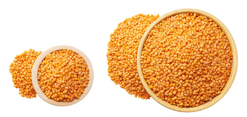 Organic red lentils are scattered out of the wooden bowl isolated on white background top view.