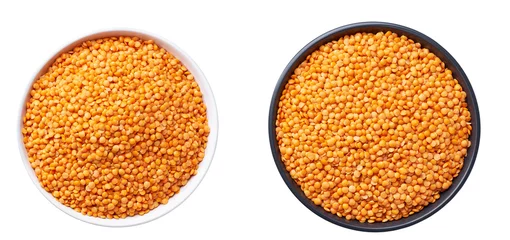 Poster organic red lentils in a ceramic plate isolated on white background top view. © Igor Dudchak