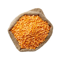 Raw red lentils in sack isolated on white background top view.