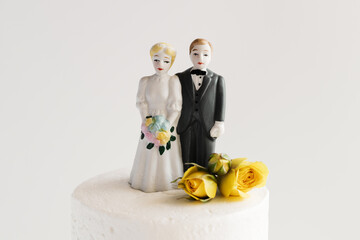A couple on top of their wedding cake