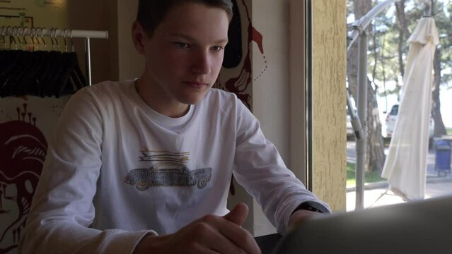 study during the holidays-concentrated boy writes a thesis on the computer