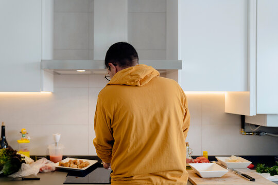 Young man cooking at home