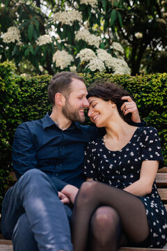 Couple talking on park bench
