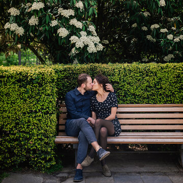 Couple kissing on park bench