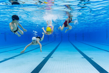 fours kids swimming in the pool