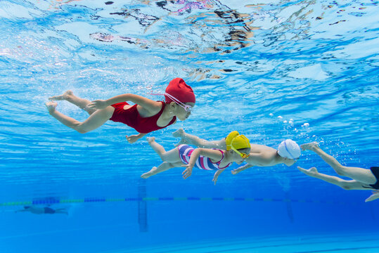 fours kids swimming underwater