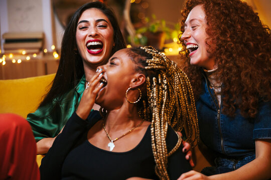 Diverse women laughing during party