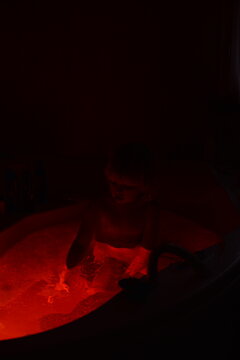 A little child taking a bath at night