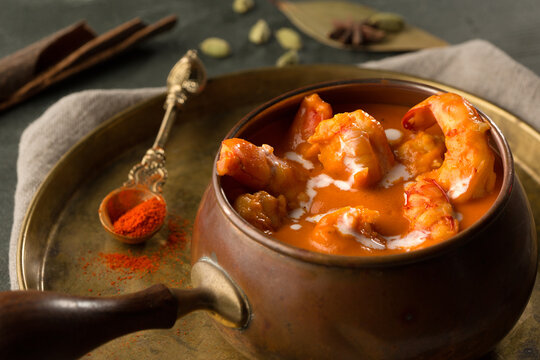 butter shrimp or jinga makhani served in dish isolated on dark background side view