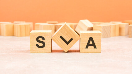 sla wooden blocks word on orange background. sla - service level agreement, information concept