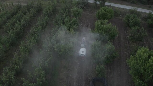 Tractor spraying pesticide drone aerial view, pesticides or insecticide spray on . Pesticides and insecticides on agricultural field in Türkiye