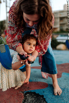 Mother testing daughter's glucose with meter