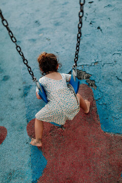 Back of girl swinging on stomach