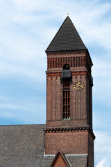 Protestant Church. Brick church tower with a golden clock. Neumünster, Germany.