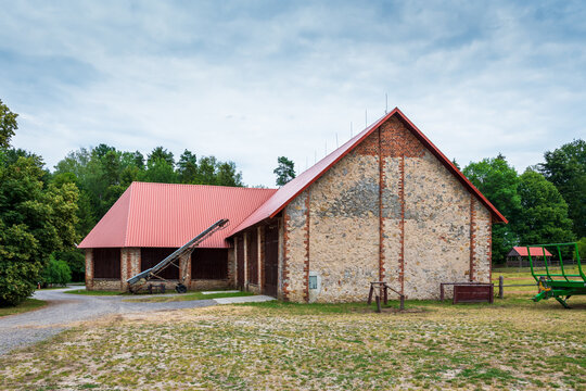 A beautiful large barn at the horse farm in Florianka. Red corrugated metal sheet on the roof of the barn